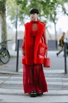 Wearing fall 2022 fashion trends for red auras, Kozue Akimoto poses wearing Sacai after the Sacai sh...